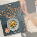 Das Kochbuch Die Risotto-Bibel ist vor einem aufgehellten Hintergrund mit zwei Buchseiten abgebildet