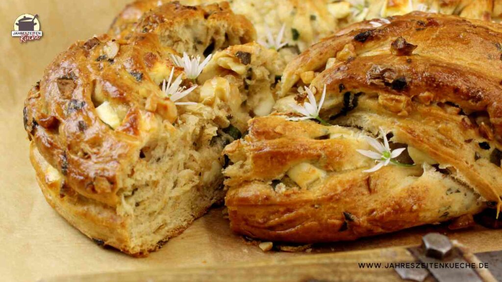 Gebackener Hefezopf mit Bärlauch und Feta bei dem ein Stück herausgeschoben wurde